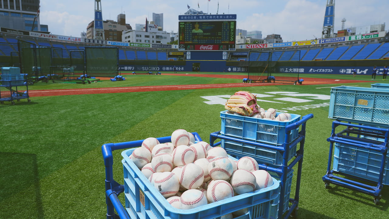 ボールがかごに入ってグラウンドに置かれている写真