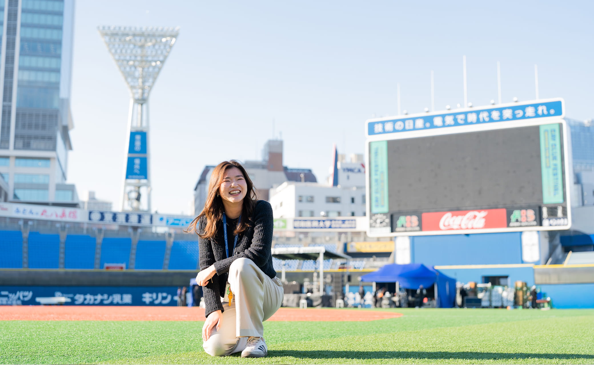 グラウンドでしゃがむ女性